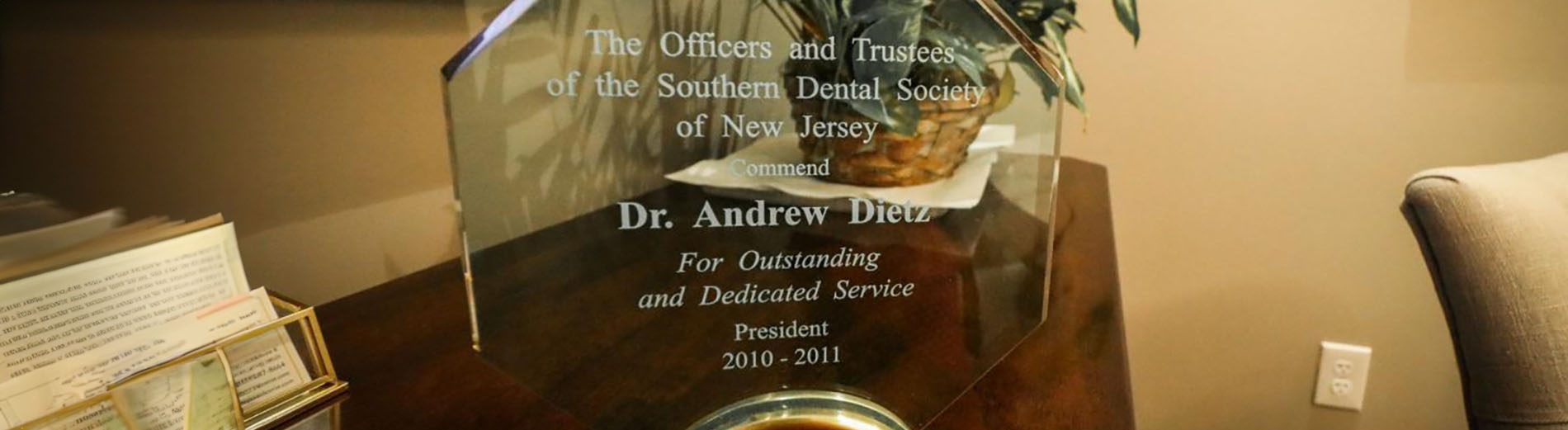 The image shows a framed award or plaque placed on a table, with text visible that reads  The Citizens   Trust of New Haven 2019-2020 Dr. Andrei Iordanu Distinguished Service Award.
