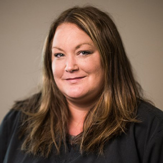 This is a split-image photograph featuring two different views of a woman with long hair smiling at the camera. She appears to be wearing a uniform, possibly indicating she works in a professional setting such as healthcare or law enforcement.